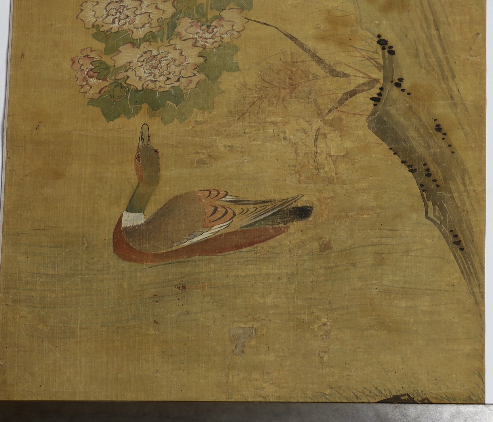 A Chinese scroll painting on silk of birds, rockwork and plants overhanging a pond, 19th century, image 164.5cm x 50.5cm